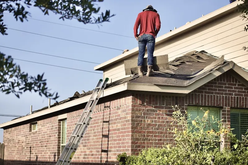 Professional roofer working on a residential roof in Secret Town